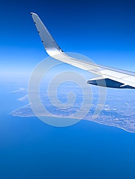 Vertical shot of the airplane flying obove the Southern California coastline