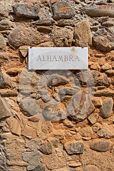 Vertical shot of the Alhambra wall sign in Alhambra Palace in Granada, Spain