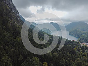 A vertical shot of an amazing view of mountains and a small lake among them