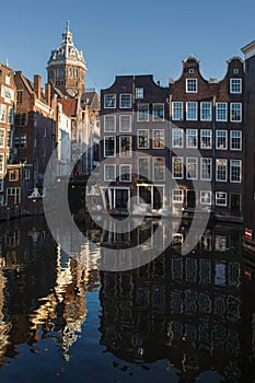 Vertical shot of the Amsterdam canal and the Basilica of Saint Nicholas in the Netherlands