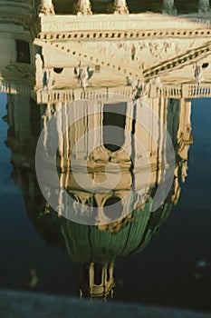 Vertical shot of the ancient royal palace reflected in water
