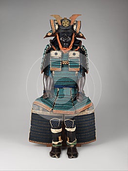 Vertical shot of ancient samurai armor isolated on gray surface background