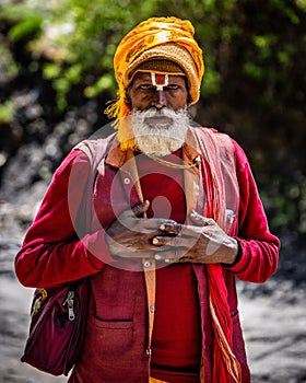 Vertical shot of a Baba Ji Pilgrim at Muktinath Mountain Temple in Mustang, Nepal