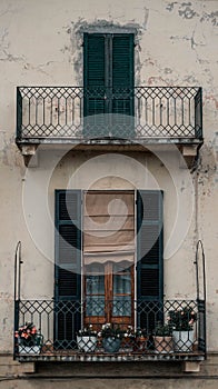 Vertical shot of balconies on the old facade of a building