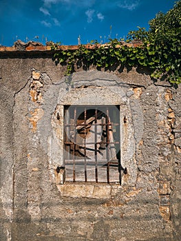 Vertical shot of barred window of an old building on a sunny day