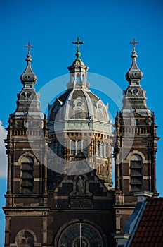 Vertical shot of the Basilica of Saint Nicholas in Amsterdam, Netherlands against a blue sky