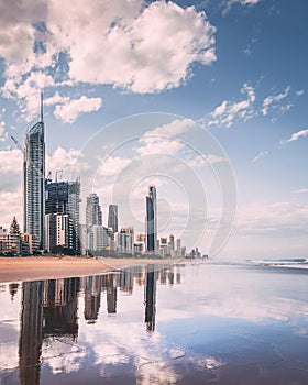 Vertical shot of a beach in the background of highrise buildings in Goldcoast, Australia