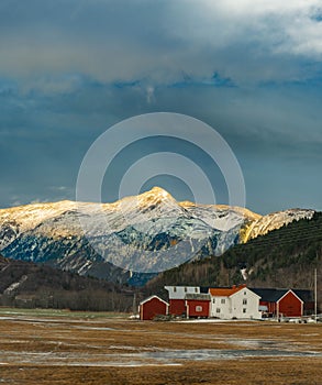 Vertical shot of beautiful rural houses near the Sunndal Mountains in Norway