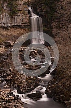 Vertical shot of the beautiful Thornton Force waterfall in Ingleton, United Kingdom