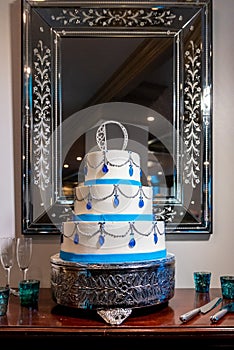 Vertical shot of a beautiful wedding cake with blue diamond decorations