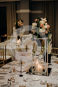 Vertical shot of a beautiful wedding venue table with candles and flowers