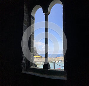 Vertical shot of a beautiful window with a view of Vernazza, Italy