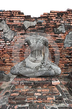Vertical shot of a beheaded Buddha Statue in Wat Chai Watthanaram Temple in Ban Pom, Thailand