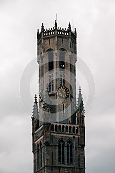 Vertical shot of Belfry of Bruges in Bruges, Belgium on a cloudy day