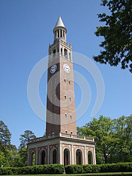 Vertical shot of a Bell Tower inside the University in Chapel Hill on a blue sky background