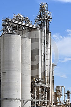 Vertical shot of a big industrial factory under a blue sky