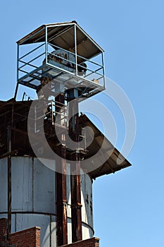 Vertical shot of a big industrial factory under a blue sky