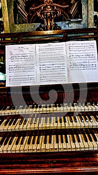Vertical shot of a big piano with note sheets