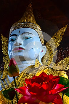 Vertical shot of the big statue of Gautama Buddha in Ngar Htat Gyi Pagoda, Yangon, Myanmar