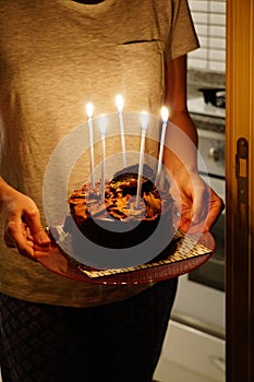 Vertical shot of a birthday celebration chocolate cake with candles