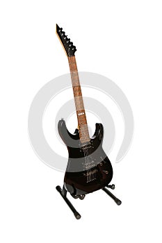 Vertical shot of a black electric guitar isolated on a white background