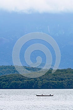 Vertical shot of a boat in the Chittar Lake at the edge of Western Ghats, Kanyakumari, India photo