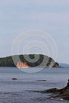 Vertical shot of a boat sailing on Frenchman Bay at Agamont Park, Bar Harbor in Maine, USA