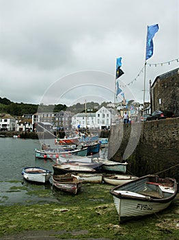 Vertical shot of the boat on the water captured in Harbour Mevagissey, UK