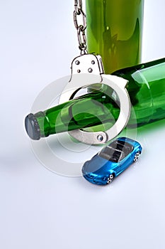 Vertical shot bottles with handcuffs and miniature car.