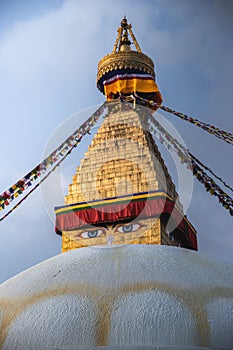 Vertical shot of the Boudhanath Stupa temple in Katmandu, Nepal with a cloudy sky in the background photo