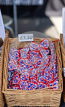 Vertical shot of a box of plastic union jack bow ties for souvenirs