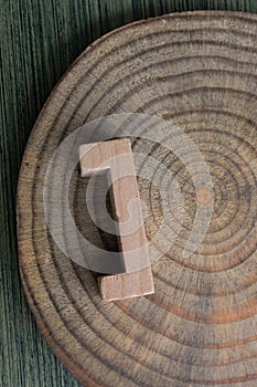 Vertical shot of a bracket made from wood on a wooden surface