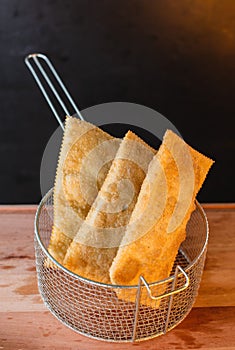 A vertical shot of Brazilian food. Pastel, pastry in English