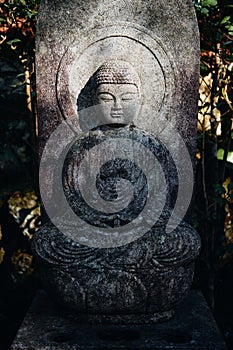 Vertical shot of a Buddhist statue in the Mitaki-Dera temple in Hiroshima, Japan