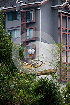 Vertical shot of a building and plants in the foreground in Meishan, Sichuan Province, China