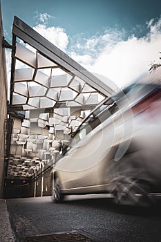 Vertical shot of a car on background of an abstract tunnel structure - perfect for wallpaper