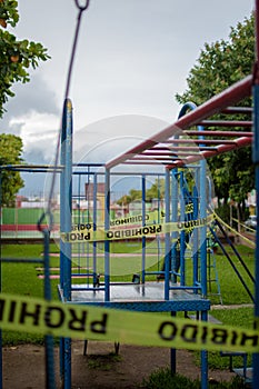 Vertical shot of caution yellow warning tapes in a park