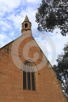 Vertical shot of a chapel surrounded by autumn trees