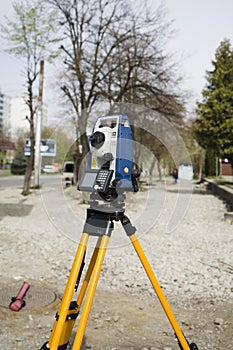 Vertical shot of  cheap geodesy level device on road