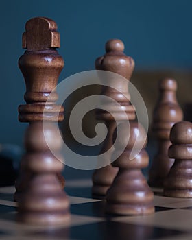 Vertical shot of chess figures - the concept of overcoming the challenges and succeeding