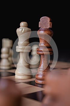 Vertical shot of chess figures - the concept of overcoming the challenges and succeeding