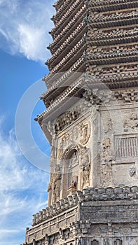 Vertical shot of Chinese temple architecture in sunlight in a blue sky background