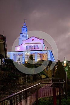 Vertical shot of a church illuminated by lights in Monserrate, Bogota, Colombia photo