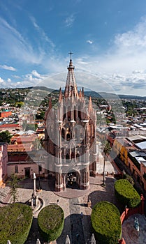 Vertical shot of the Church of St. Michael (Parroquia de San Miguel Arcangel) against a blue sky photo