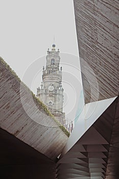 Vertical shot of the Clerigos Church and Tower seen through other building in Porto, Portugal