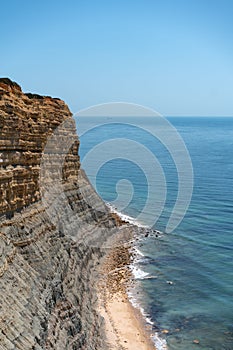 Vertical shot of a cliffy coast in southern Portugal photo