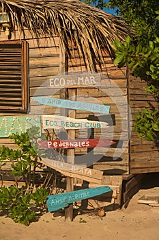 Vertical shot of a collection of signs at the Eco del Mar hotel showing directions photo