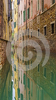 Vertical shot of colorful canal houses in venice