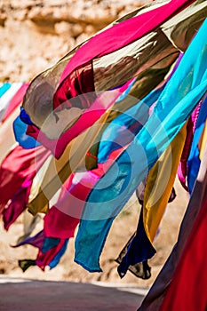 Vertical shot of colorful garments handing on a rope outdoors