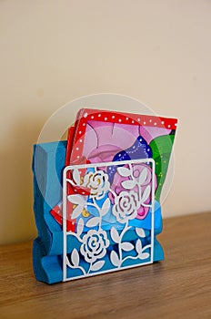 Vertical shot of colorful paper napkins in a holder on the table